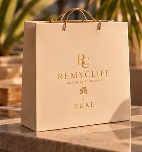 The PURE ivory shopping bag with gold branding